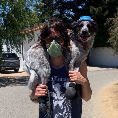 Photo of Katherine Moennig carrying her dog.